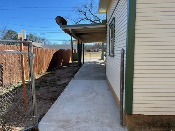 a front view of a house with garden and sitting area
