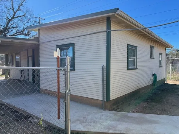 a view of a backyard with sitting area