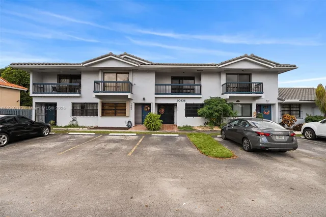a view of a car parked in front of a brick house