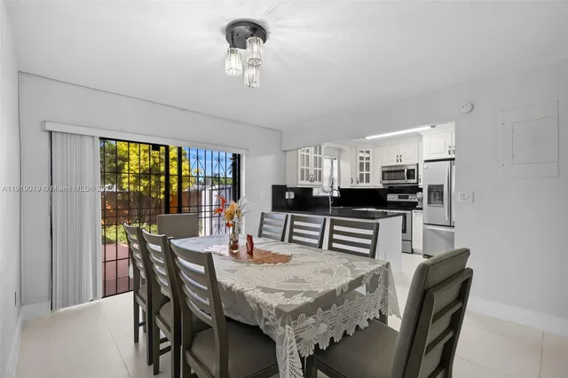 a kitchen with granite countertop a refrigerator and a sink
