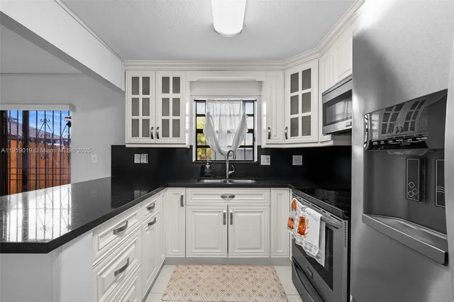 a utility room with sink dryer and washer