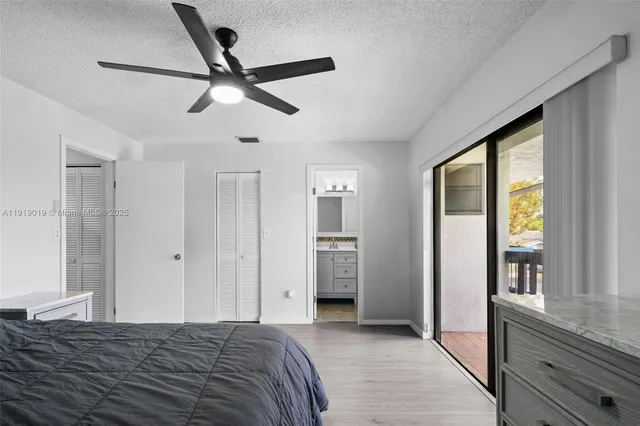 a bathroom with a sink a toilet a mirror and shower