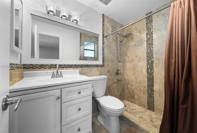 a view of backyard and wooden fence