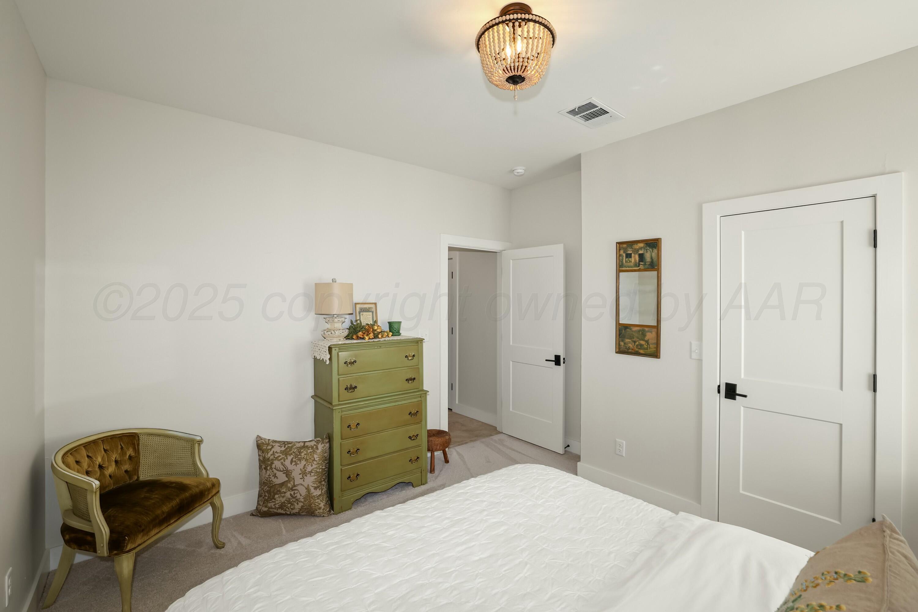 19081 Elk Springs Road Amarillo, TX 79119 - Photo 32 of 41 a bedroom with a bed and furniture