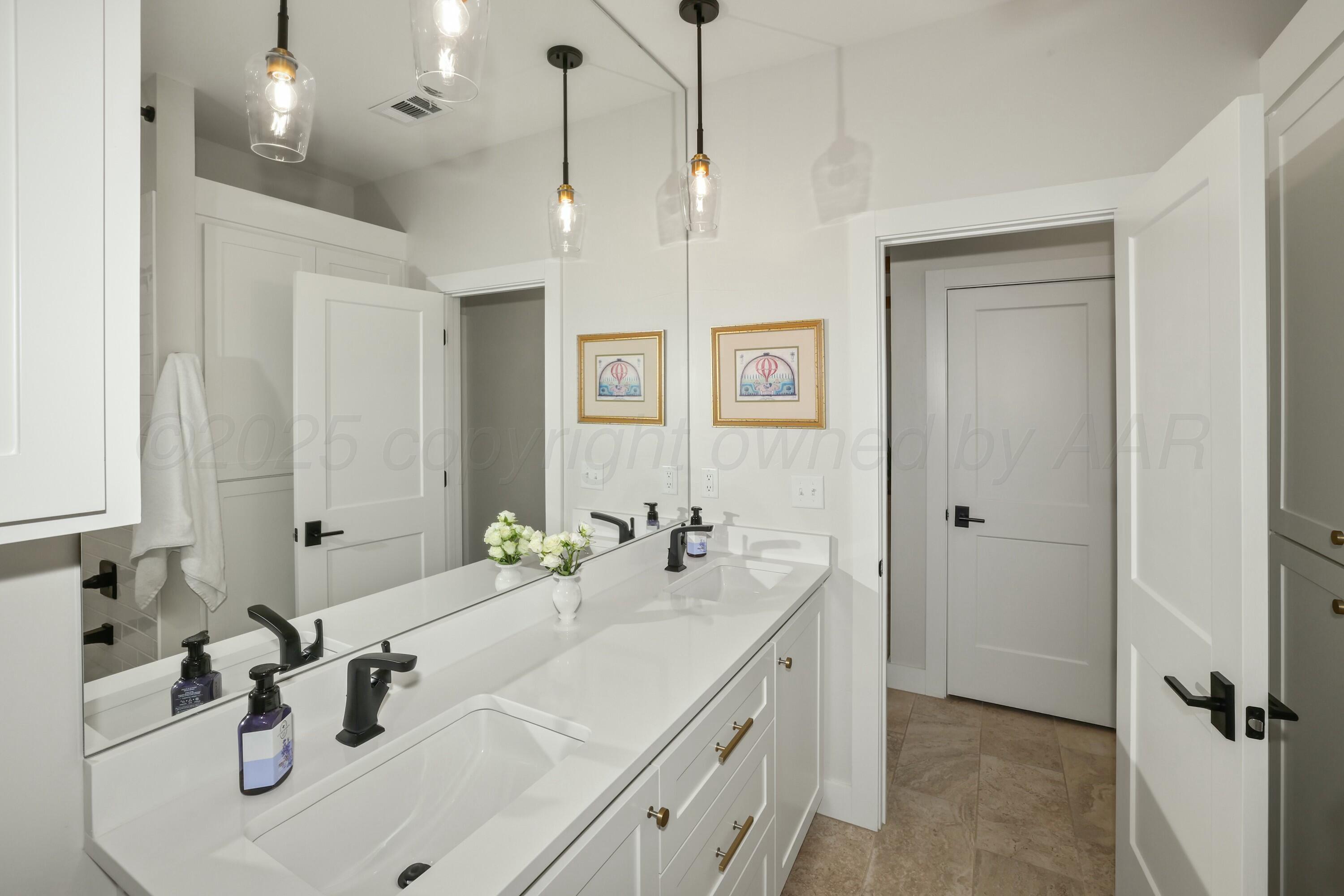 19081 Elk Springs Road Amarillo, TX 79119 - Photo 34 of 41 a bathroom with a sink and a mirror