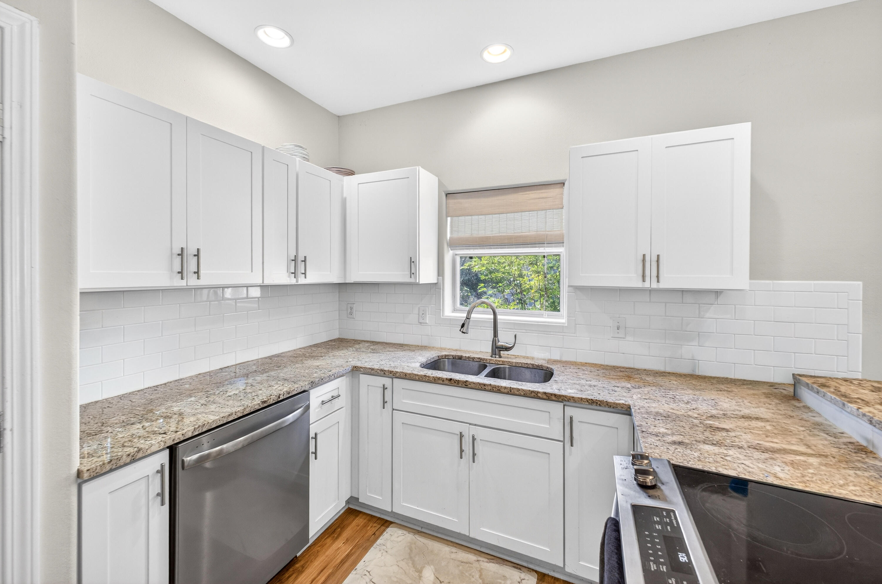56 East Shallows Drive Santa Rosa Beach, FL 32459 - Photo 13 of 54 a kitchen with granite countertop white cabinets white appliances and a sink