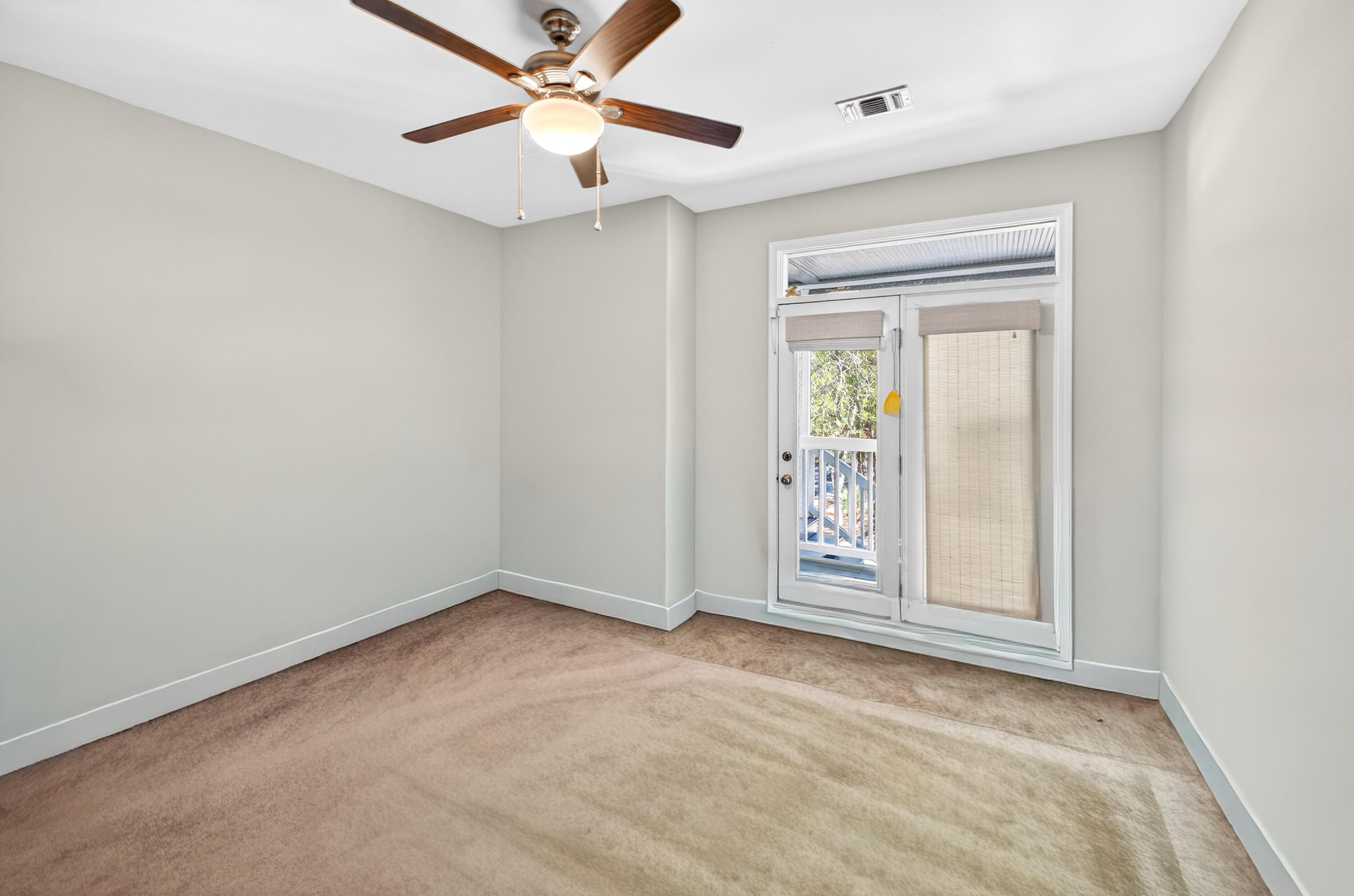 56 East Shallows Drive Santa Rosa Beach, FL 32459 - Photo 15 of 54 an empty room with windows and fan