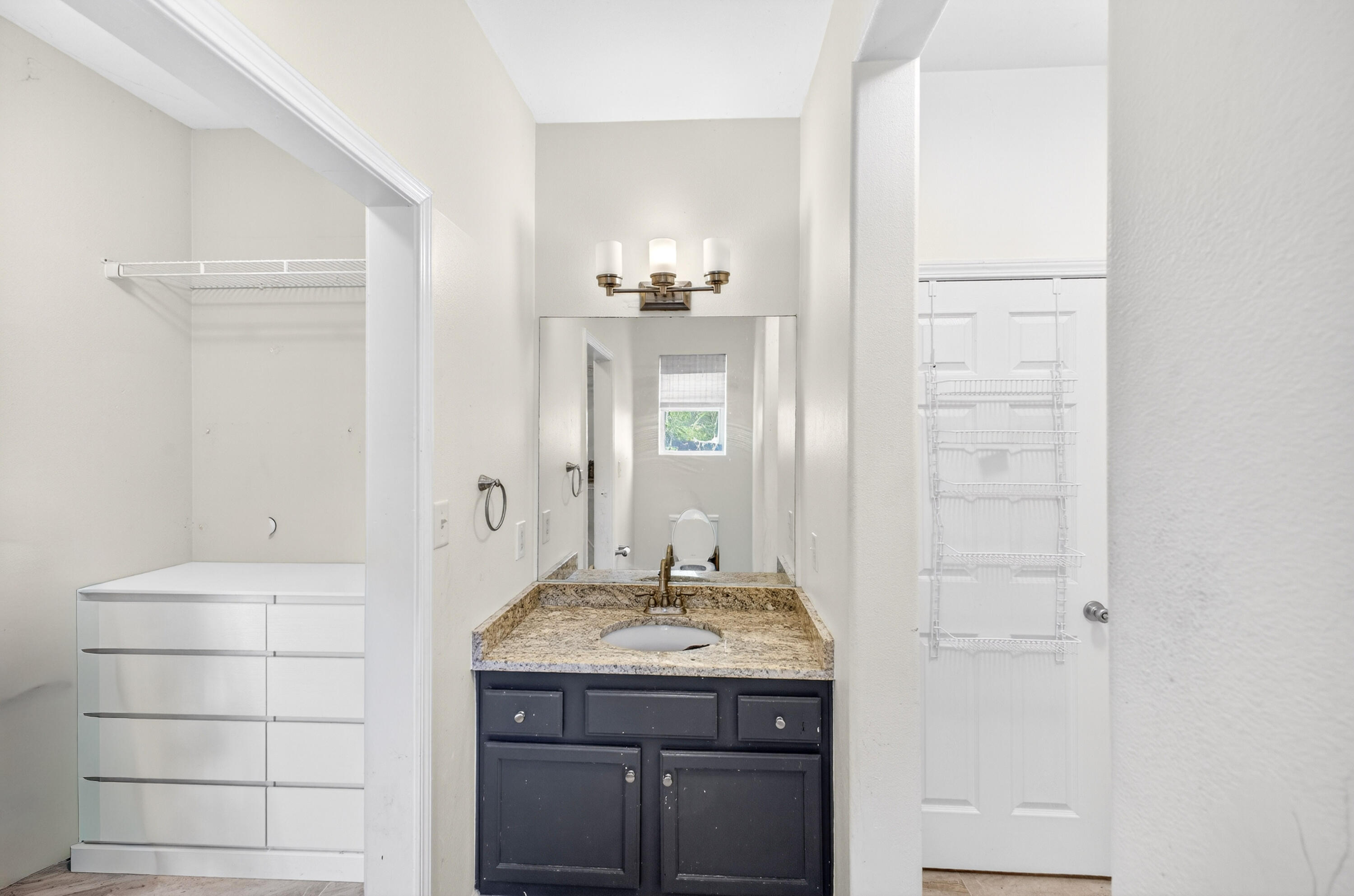 56 East Shallows Drive Santa Rosa Beach, FL 32459 - Photo 29 of 54 a bathroom with a granite countertop sink and a mirror