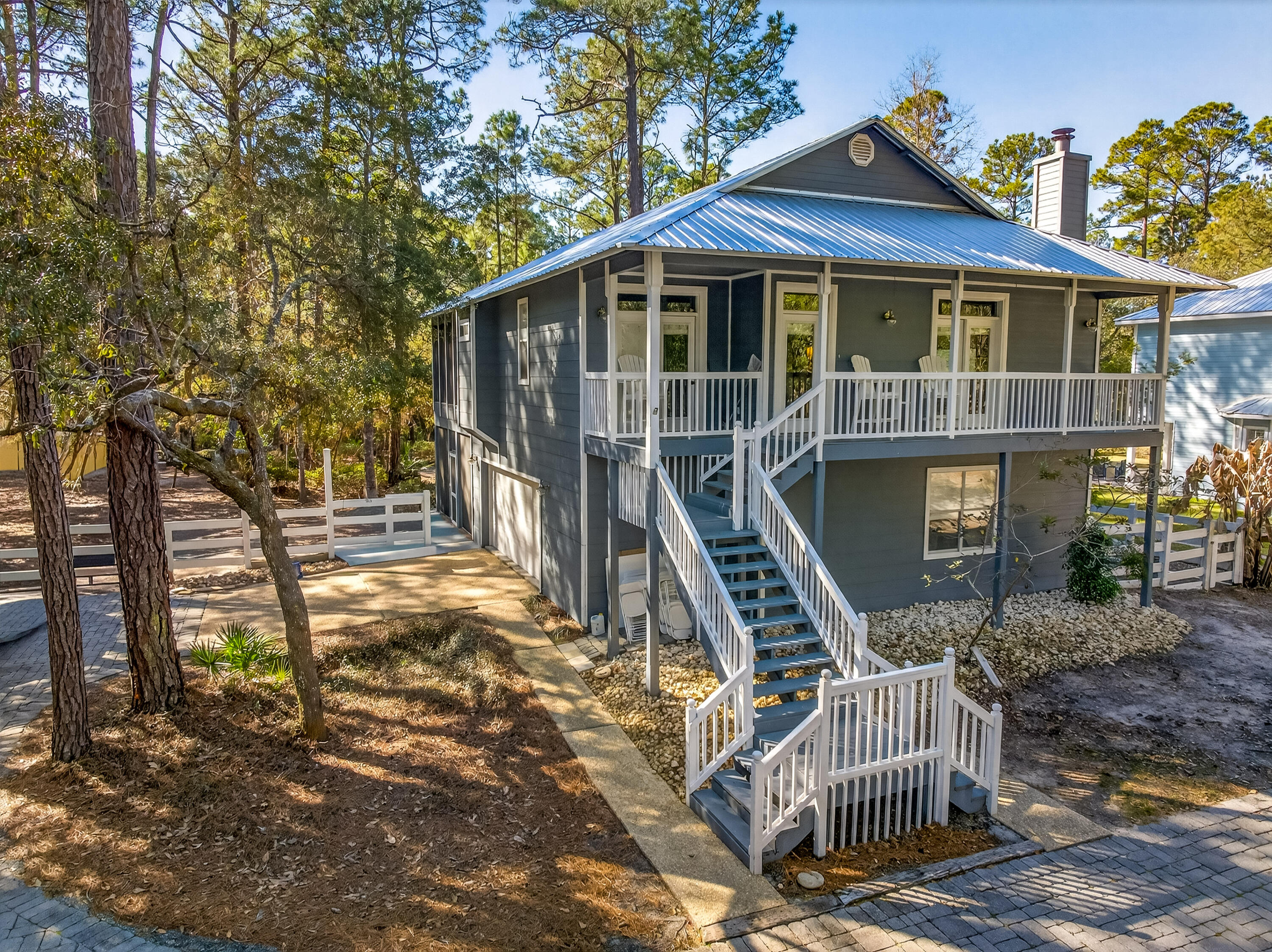 56 East Shallows Drive Santa Rosa Beach, FL 32459 - Photo 3 of 54 a front view of a house with glass top table and chairs