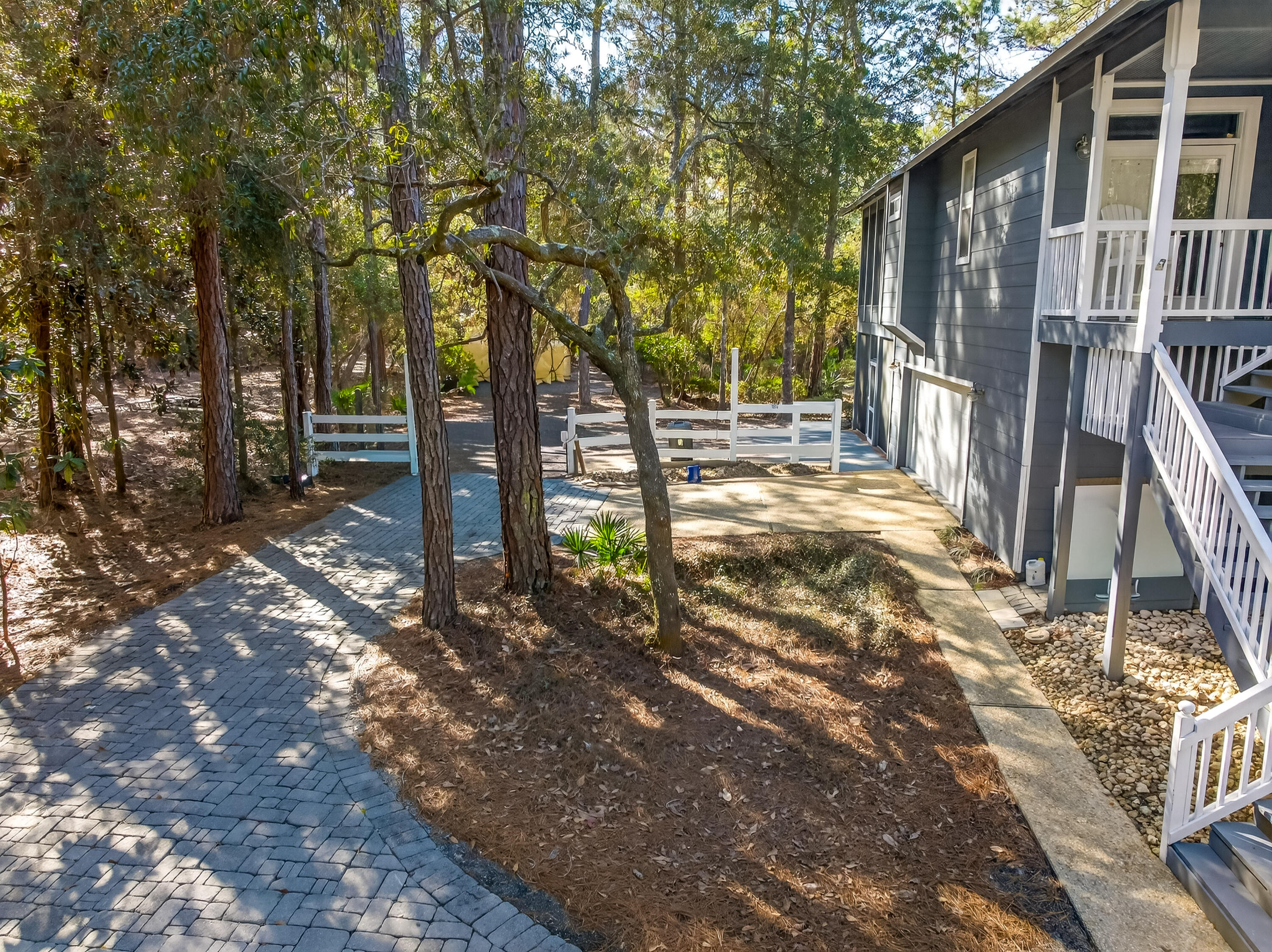 56 East Shallows Drive Santa Rosa Beach, FL 32459 - Photo 38 of 54 a view of a backyard with wooden fence and large trees