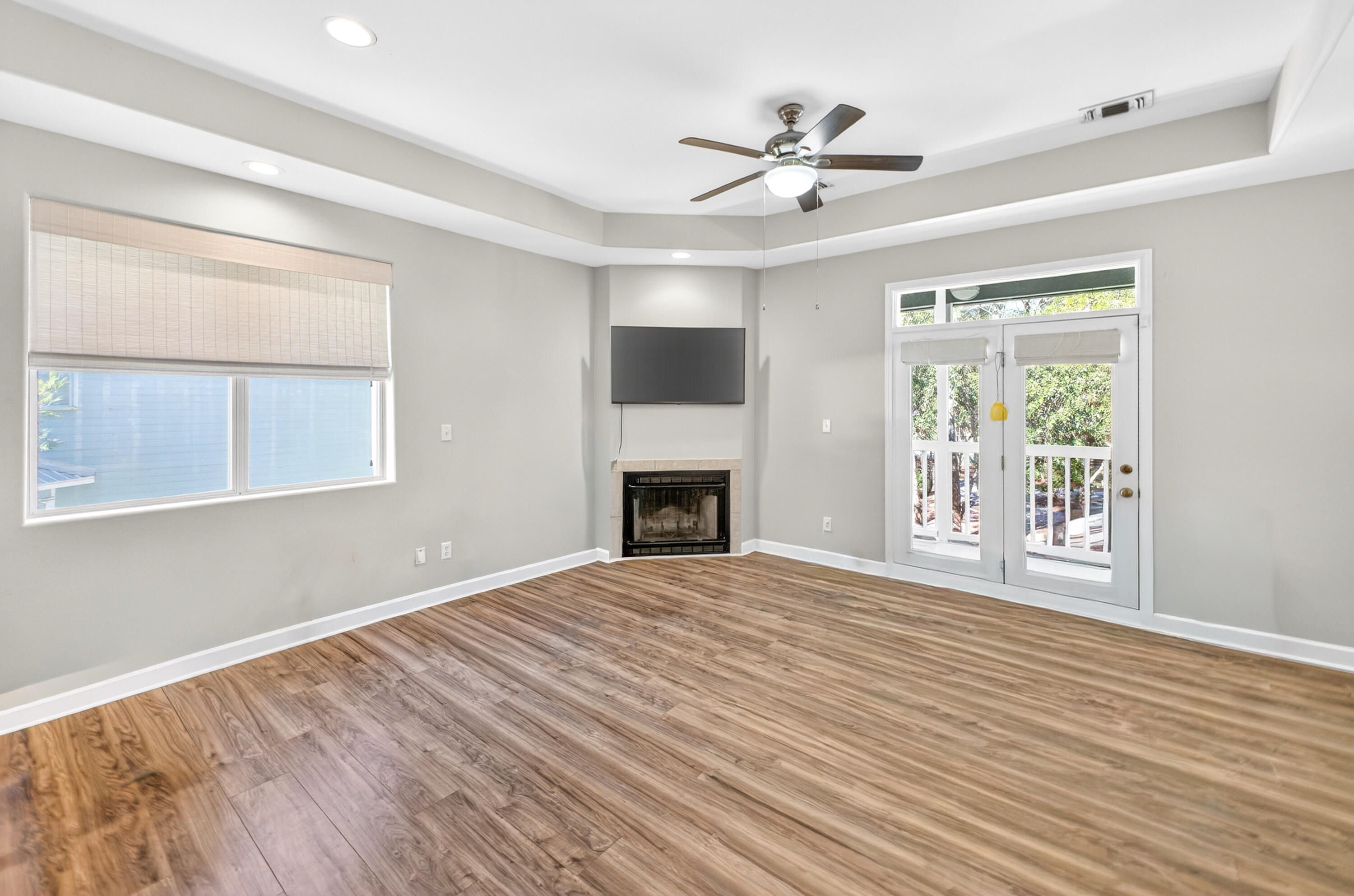 56 East Shallows Drive Santa Rosa Beach, FL 32459 - Photo 9 of 54 a view of an empty room with wooden floor fireplace and a window