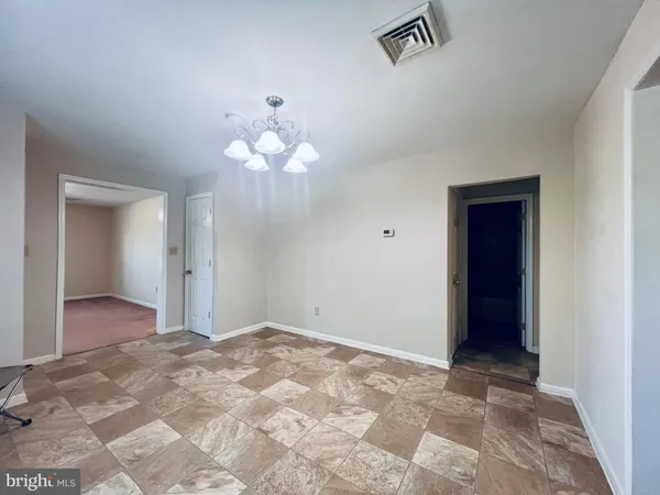 a view of a chandelier fan and entryway
