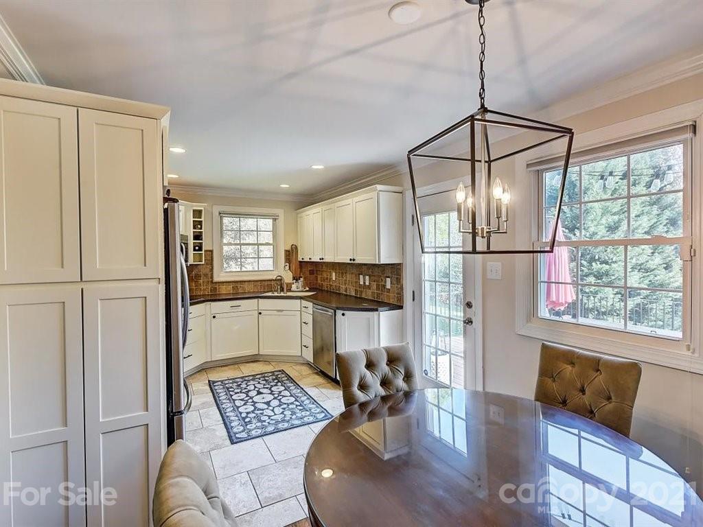 5121 Murrayhill Road Charlotte, NC 28210 - Photo 11 of 47 a kitchen with stainless steel appliances granite countertop a refrigerator dining table and chairs