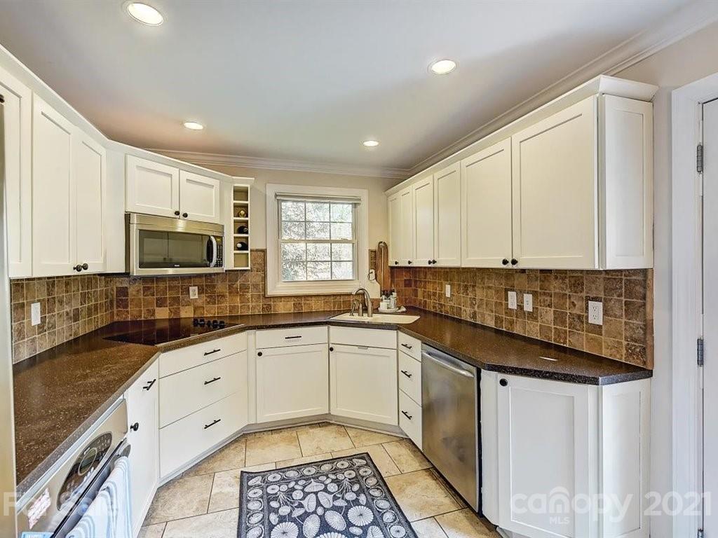 5121 Murrayhill Road Charlotte, NC 28210 - Photo 14 of 47 a kitchen with granite countertop a sink stove and cabinets
