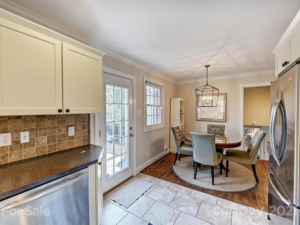 5121 Murrayhill Road Charlotte, NC 28210 - Photo 17 of 47 a view of a dining room with furniture a chandelier and wooden floor