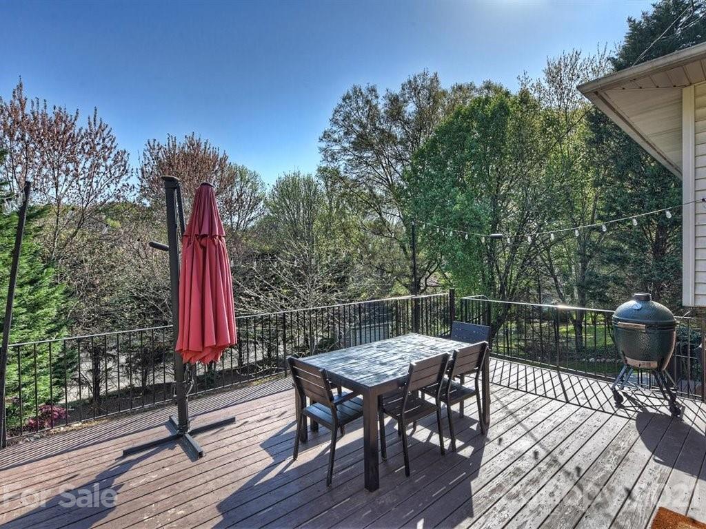 5121 Murrayhill Road Charlotte, NC 28210 - Photo 35 of 47 a view of a roof deck with table and chairs with wooden floor and fence