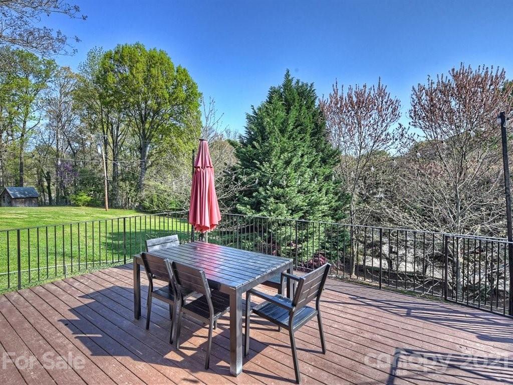 5121 Murrayhill Road Charlotte, NC 28210 - Photo 36 of 47 a view of a wooden deck with table and chairs with wooden floor and fence