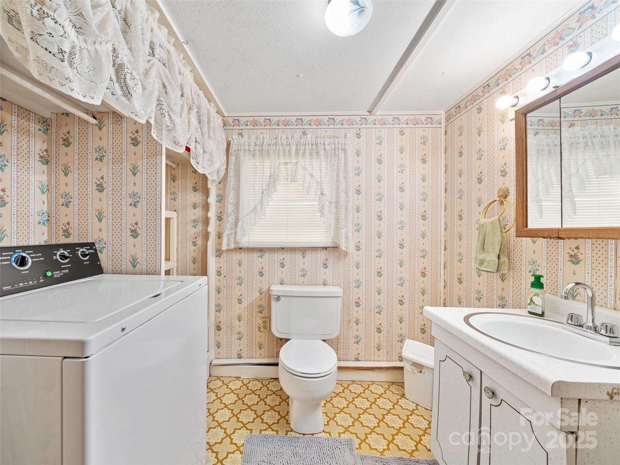 2850 Henson Creek Road Newland, NC 28657 - Photo 16 of 27 a bathroom with a sink toilet a mirror and shower