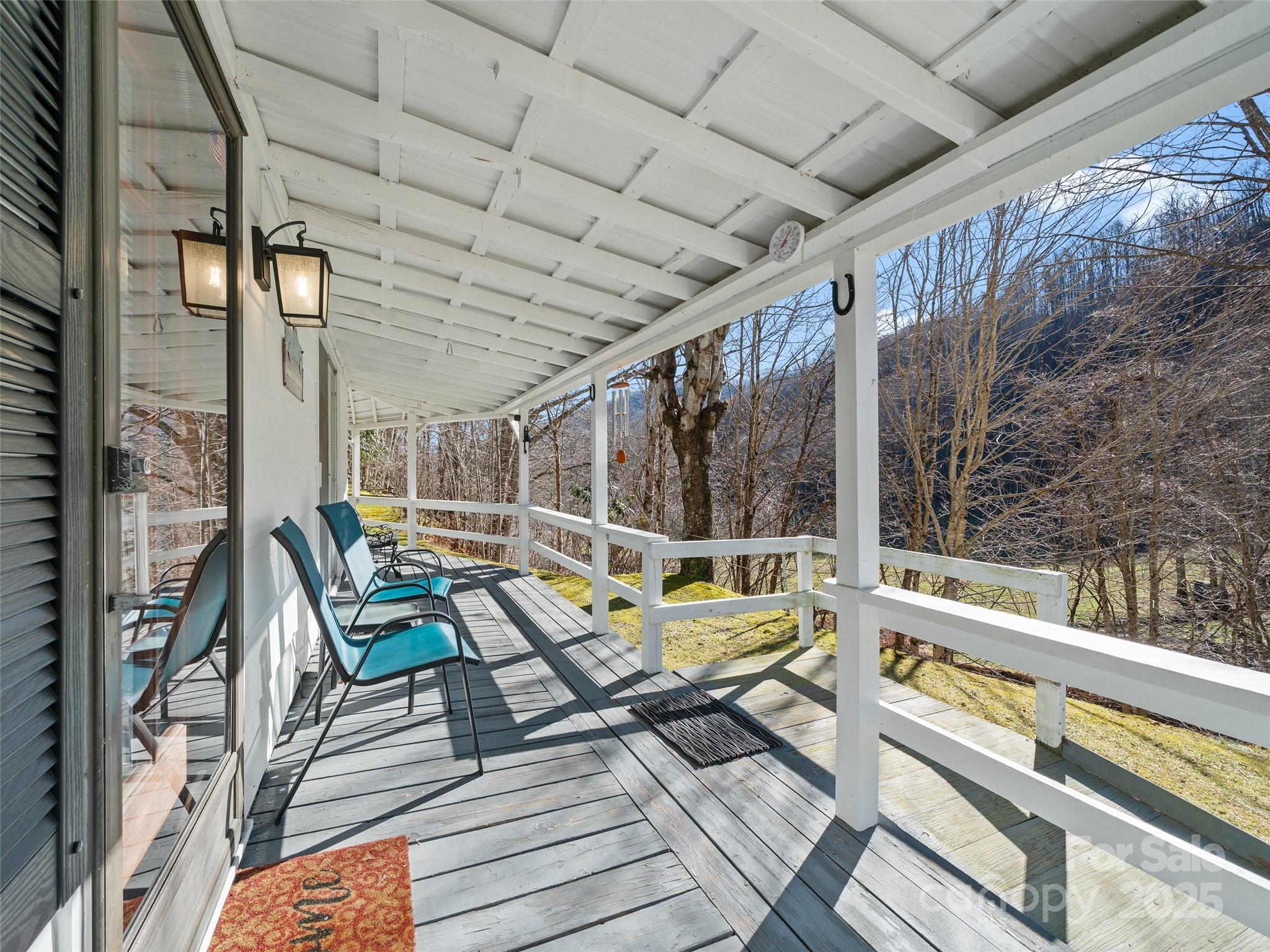 2850 Henson Creek Road Newland, NC 28657 - Photo 17 of 27 a sitting area with furniture on wooden deck