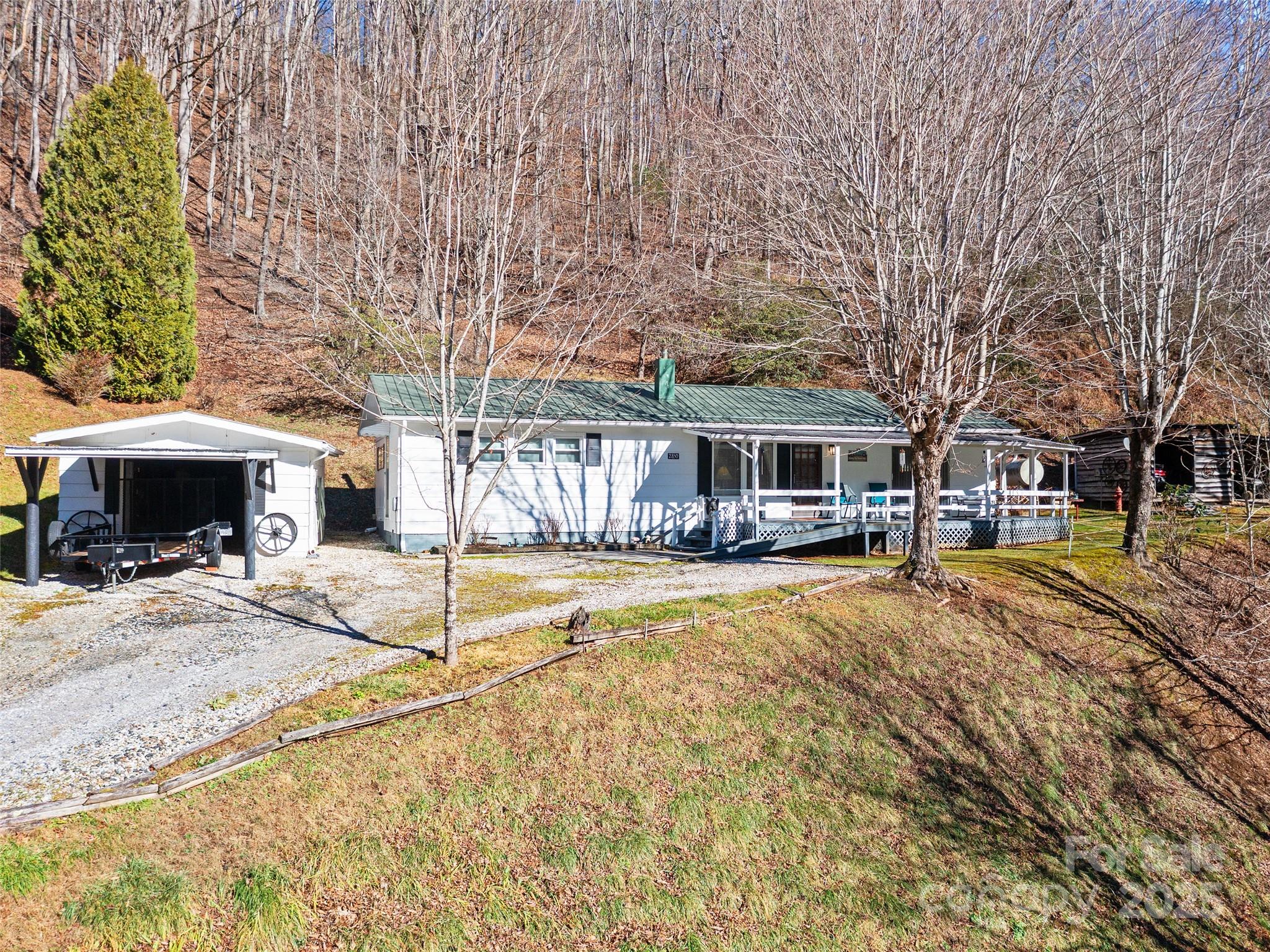 2850 Henson Creek Road Newland, NC 28657 - Photo 20 of 27 a view of a house with snow on the side of the road