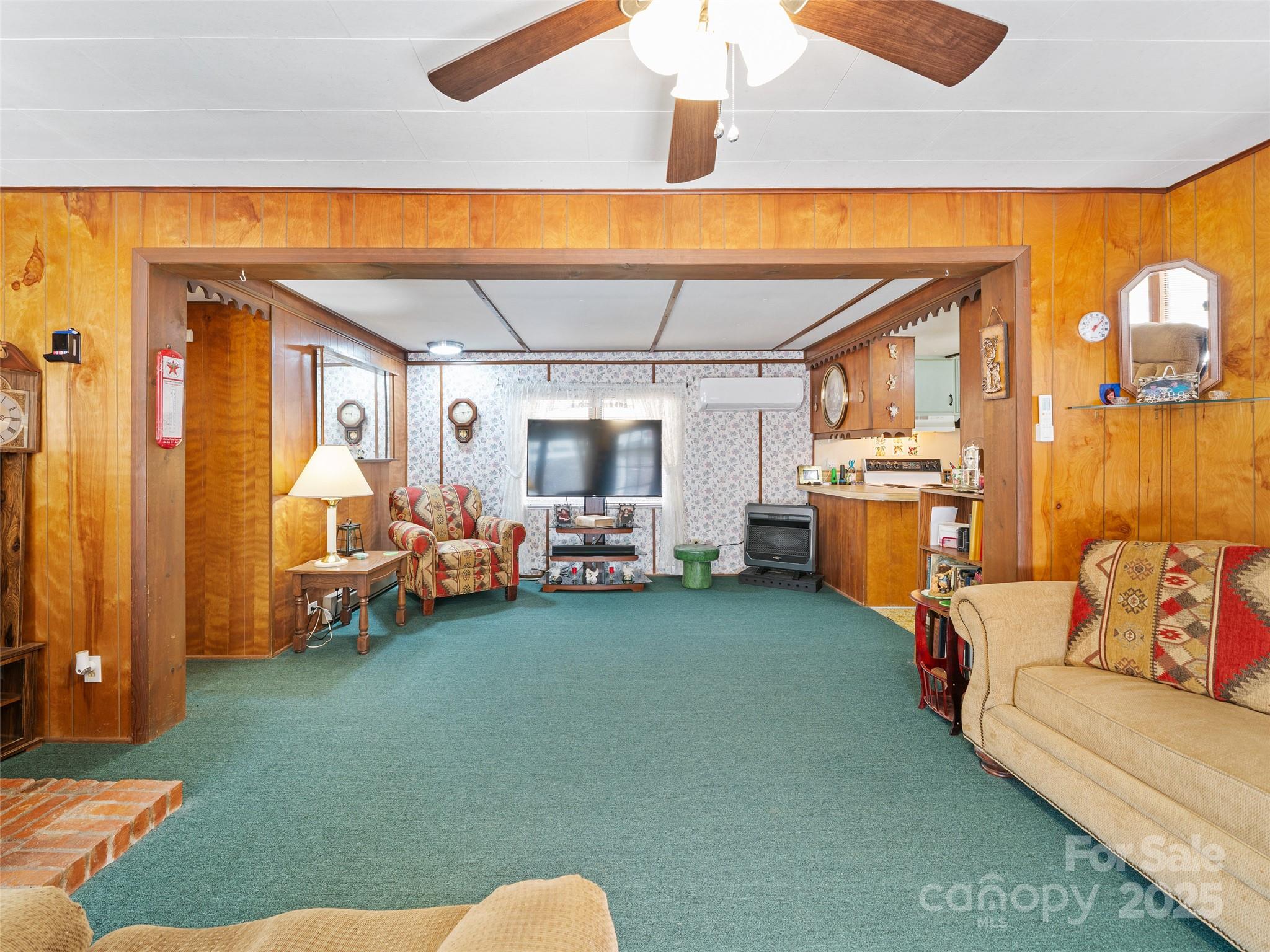 2850 Henson Creek Road Newland, NC 28657 - Photo 5 of 27 a bed room with furniture and a flat screen tv