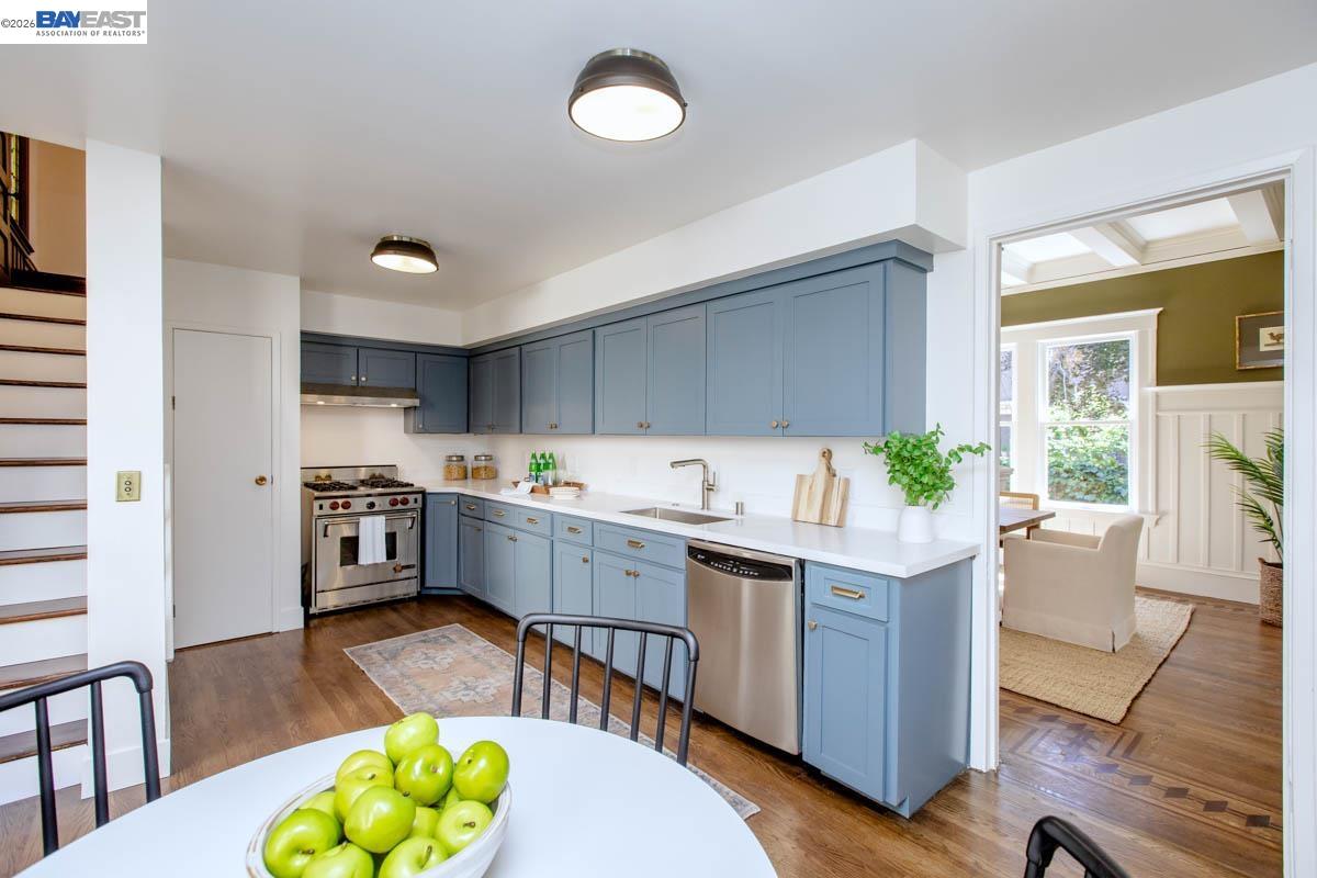 1111 Union Street Alameda, CA 94501 - Photo 22 of 57 a kitchen with stainless steel appliances granite countertop a sink cabinets and wooden floor