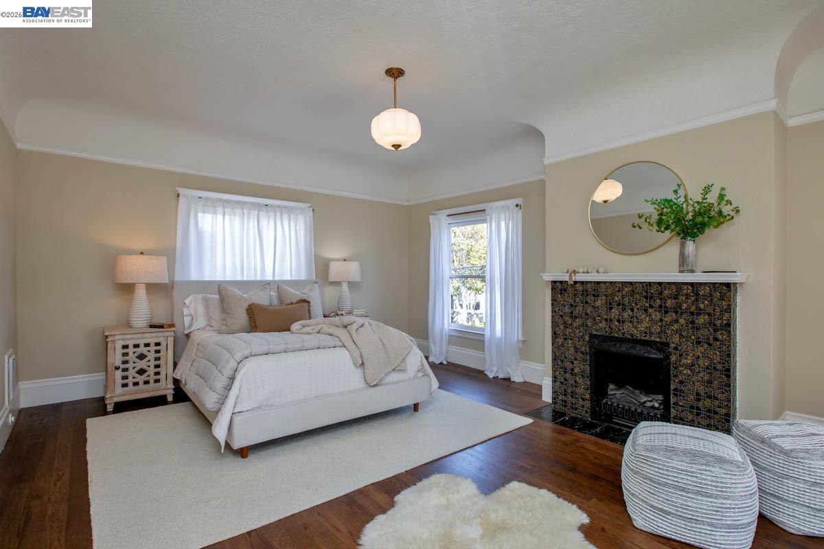 1111 Union Street Alameda, CA 94501 - Photo 34 of 57 a spacious bedroom with a bed and a fireplace