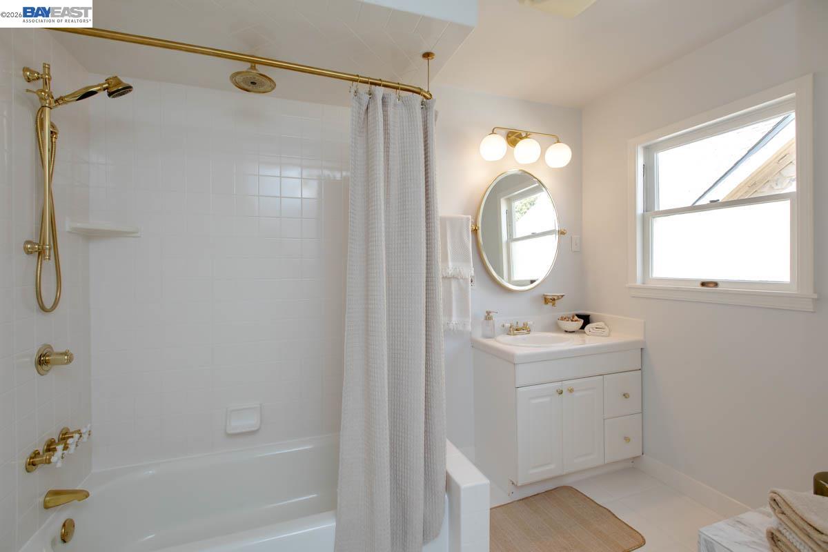 1111 Union Street Alameda, CA 94501 - Photo 49 of 57 a bathroom with a sink a toilet and a mirror