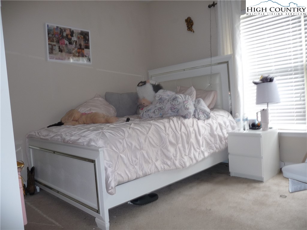 186 Cecil Miller Road, Unit 202 Boone, NC 28607 - Photo 11 of 15 a bedroom with a bed and window