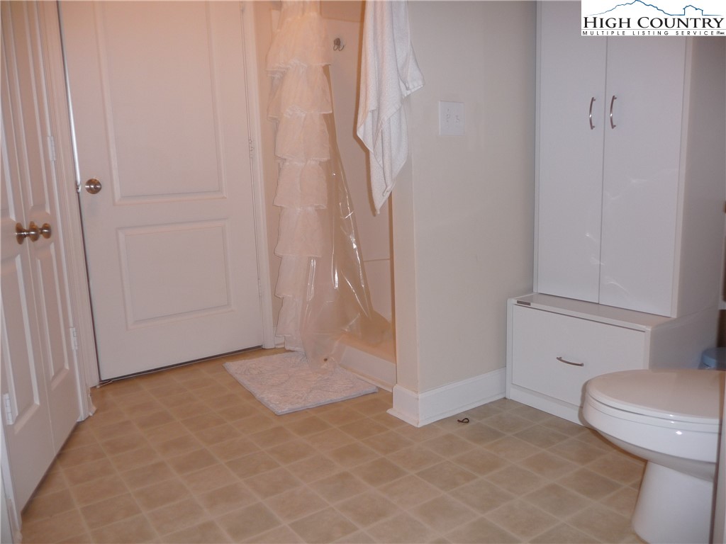 186 Cecil Miller Road, Unit 202 Boone, NC 28607 - Photo 12 of 15 a bathroom with a toilet and a shower