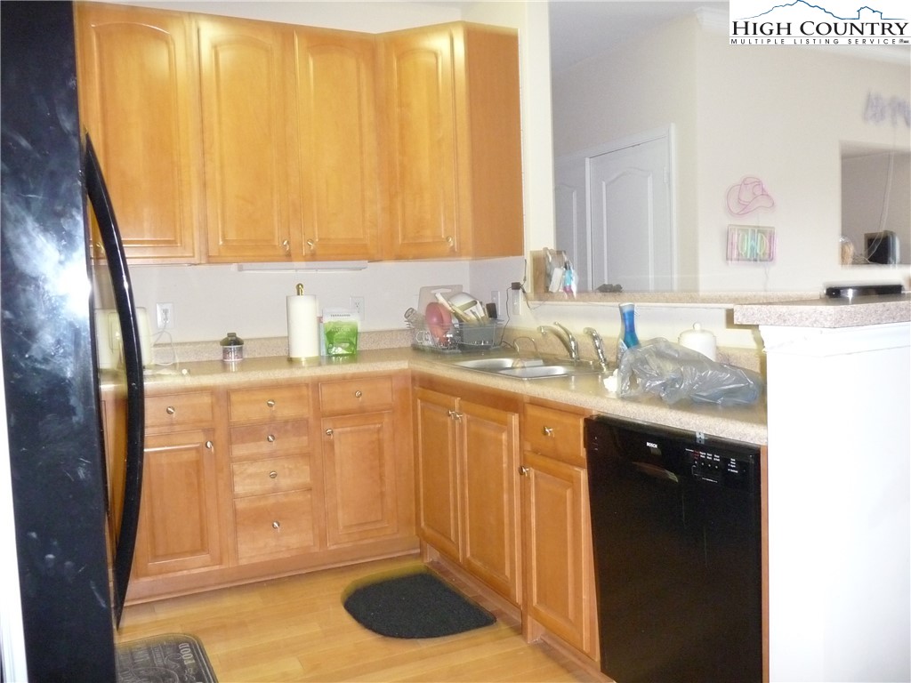 186 Cecil Miller Road, Unit 202 Boone, NC 28607 - Photo 4 of 15 a bathroom with a granite countertop sink and a mirror