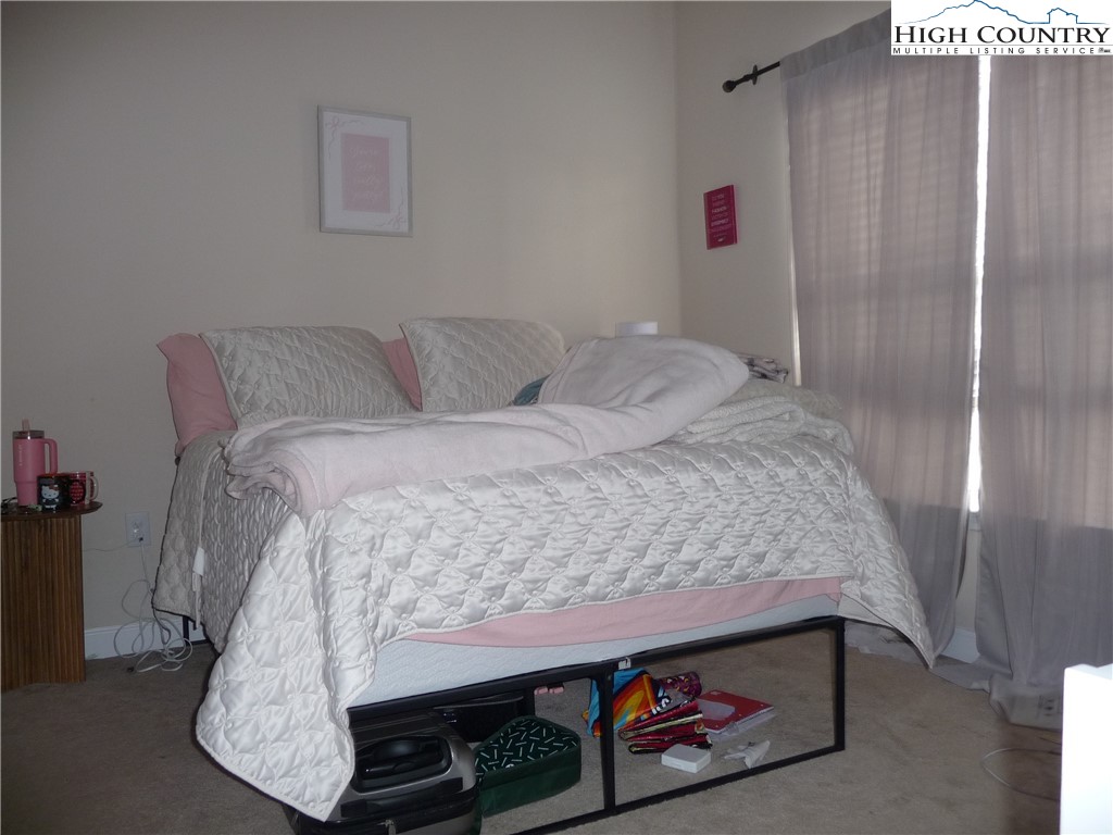 186 Cecil Miller Road, Unit 202 Boone, NC 28607 - Photo 7 of 15 a bedroom with a bed and a dresser