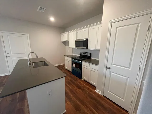 a kitchen with a sink a stove and refrigerator