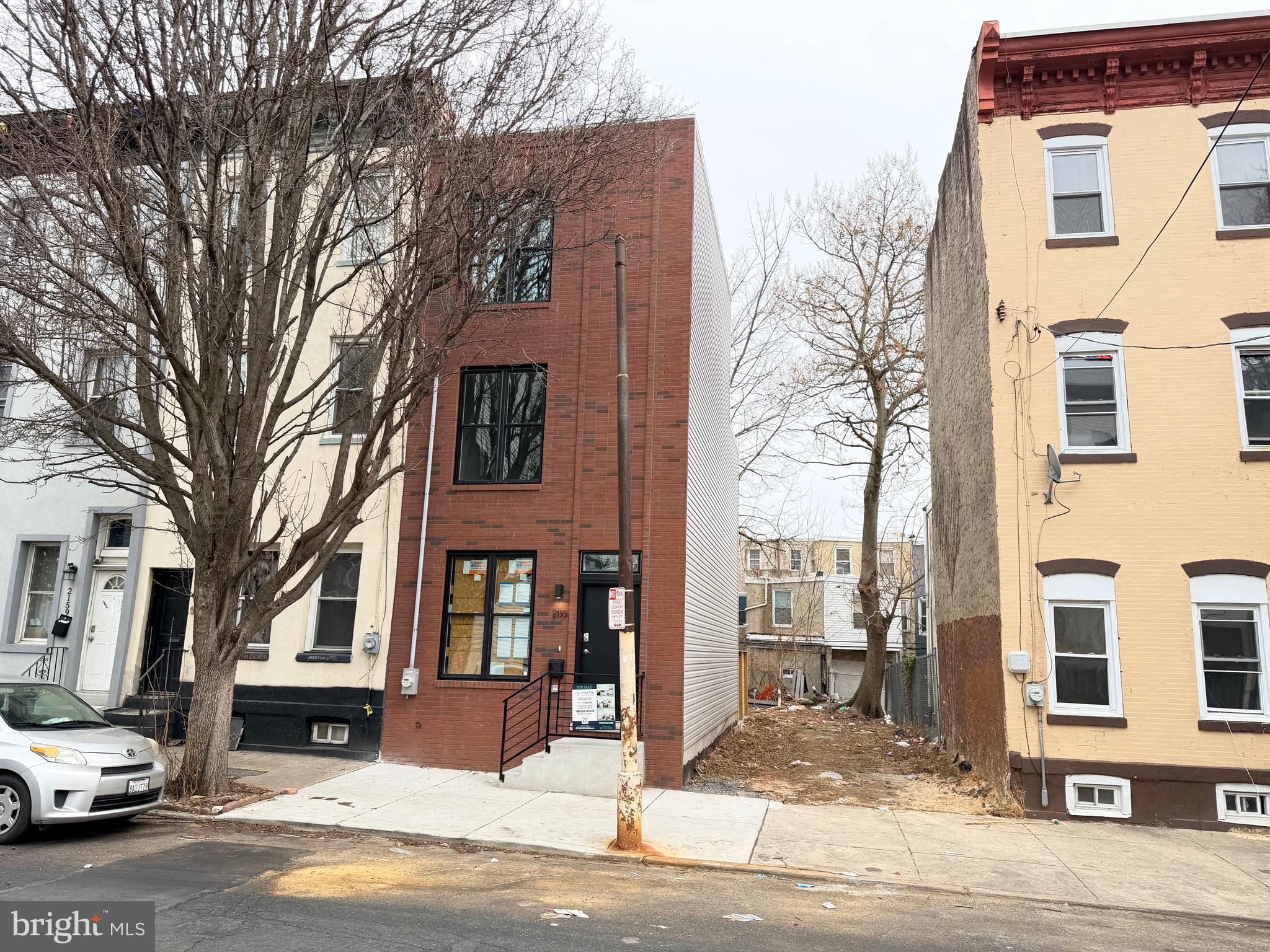 2153 North 8th Street Philadelphia, PA 19122 - Photo 2 of 4 a front view of a residential apartment building with a yard
