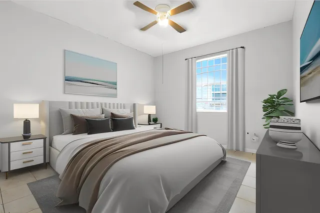 a bedroom with a large bed and a chandelier