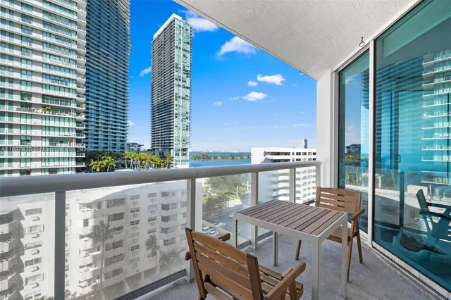 a view of a balcony with table and chairs