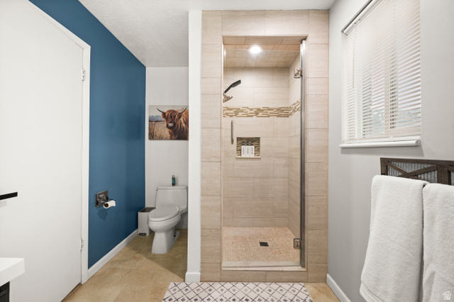 9750 Indian Ridge Drive Sandy, UT 84092 - Photo 36 of 40 Bathroom featuring a shower stall, vanity, and light tile patterned floors