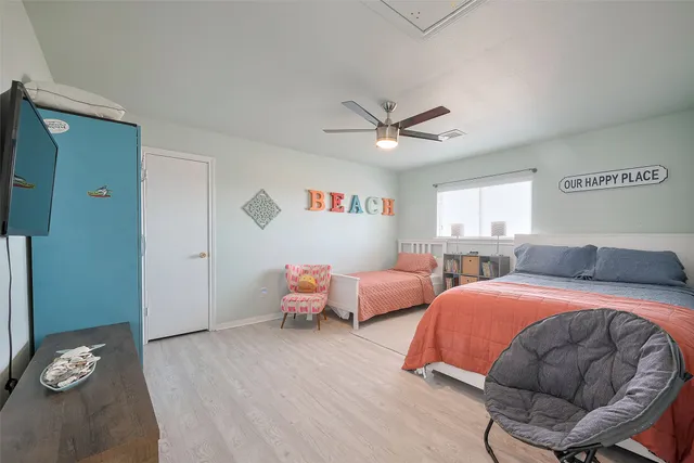 a bedroom with two beds and a chandelier