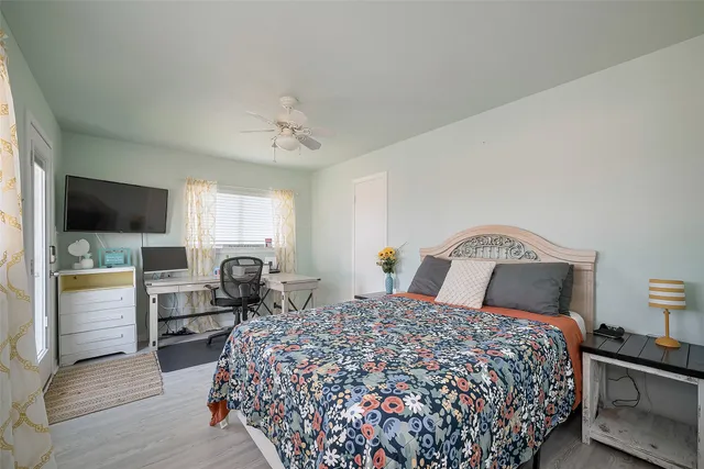 a bedroom with a large bed and flat tv