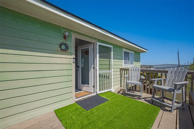 a view of a house with backyard porch and sitting area