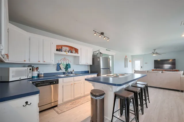 a kitchen with granite countertop a sink and cabinets
