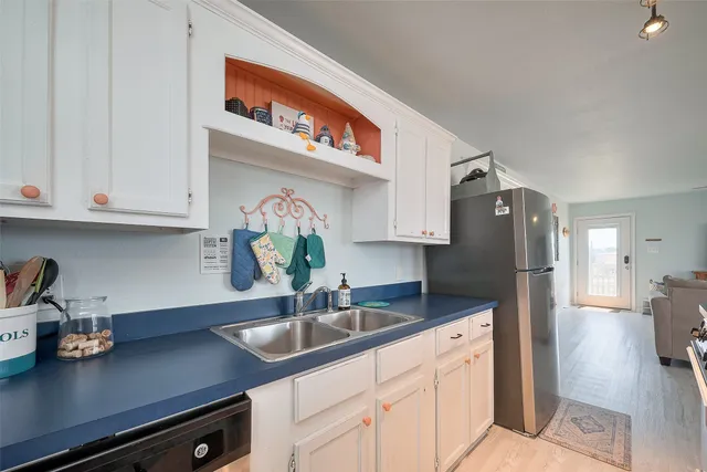 a kitchen with stainless steel appliances granite countertop a sink a stove and cabinets