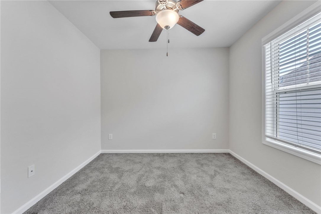 208 Samuel Street Pendleton, SC 29670 - Photo 21 of 32 A well-lit bedroom features plush carpeting and a modern ceiling fan for ultimate comfort.