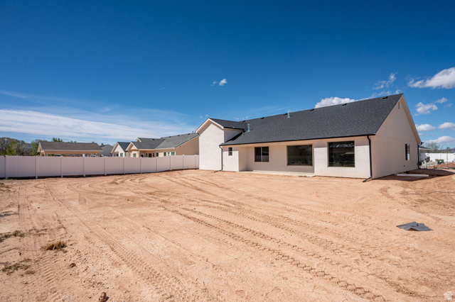4978 North 75 East Enoch, UT 84721 - Photo 38 of 60 Rear view of house with stucco siding and a shingled roof