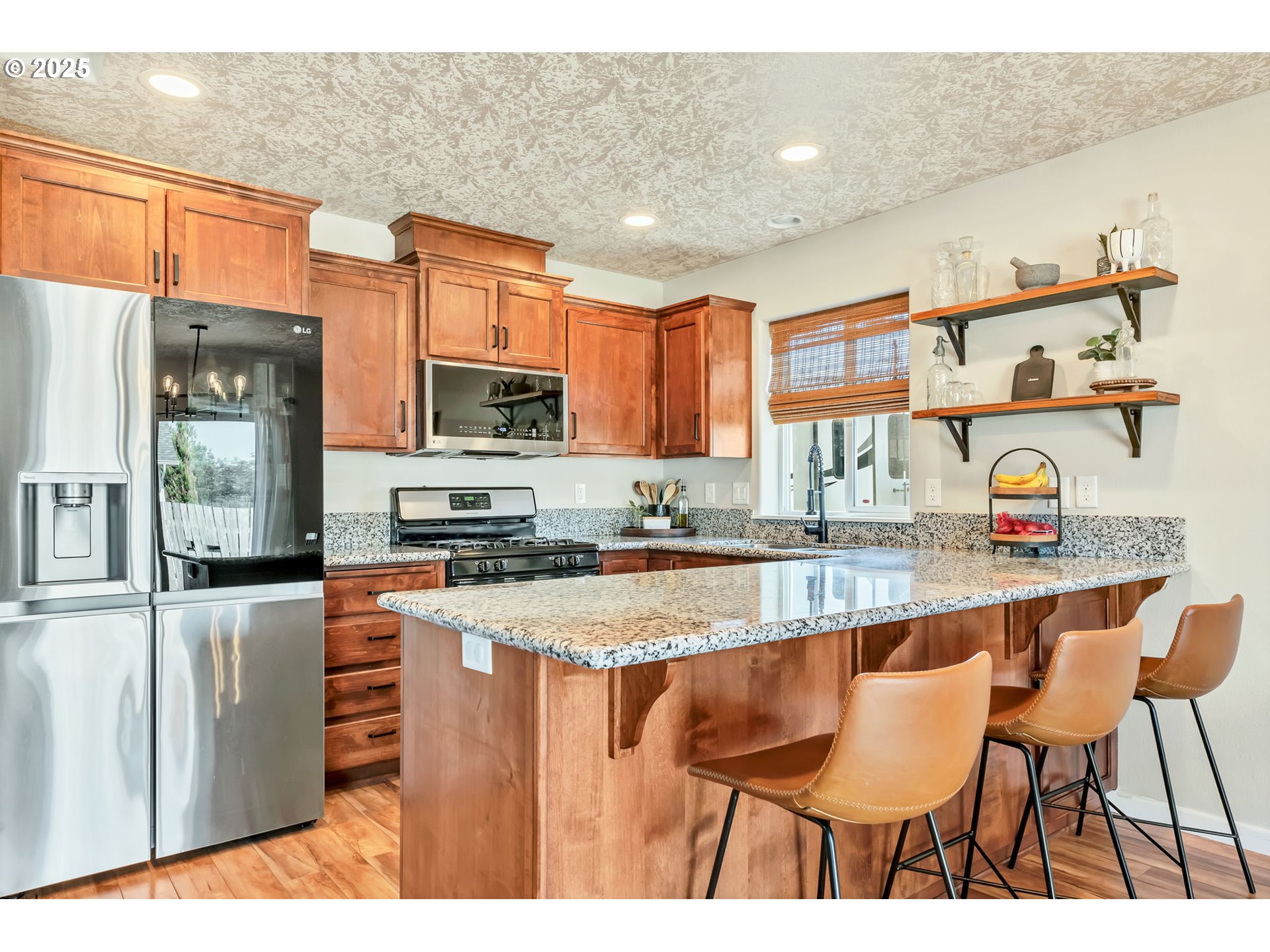 525 12th Street Aumsville, OR 97325 - Photo 6 of 23 a kitchen with stainless steel appliances granite countertop a stove top oven a sink a dining table and chairs