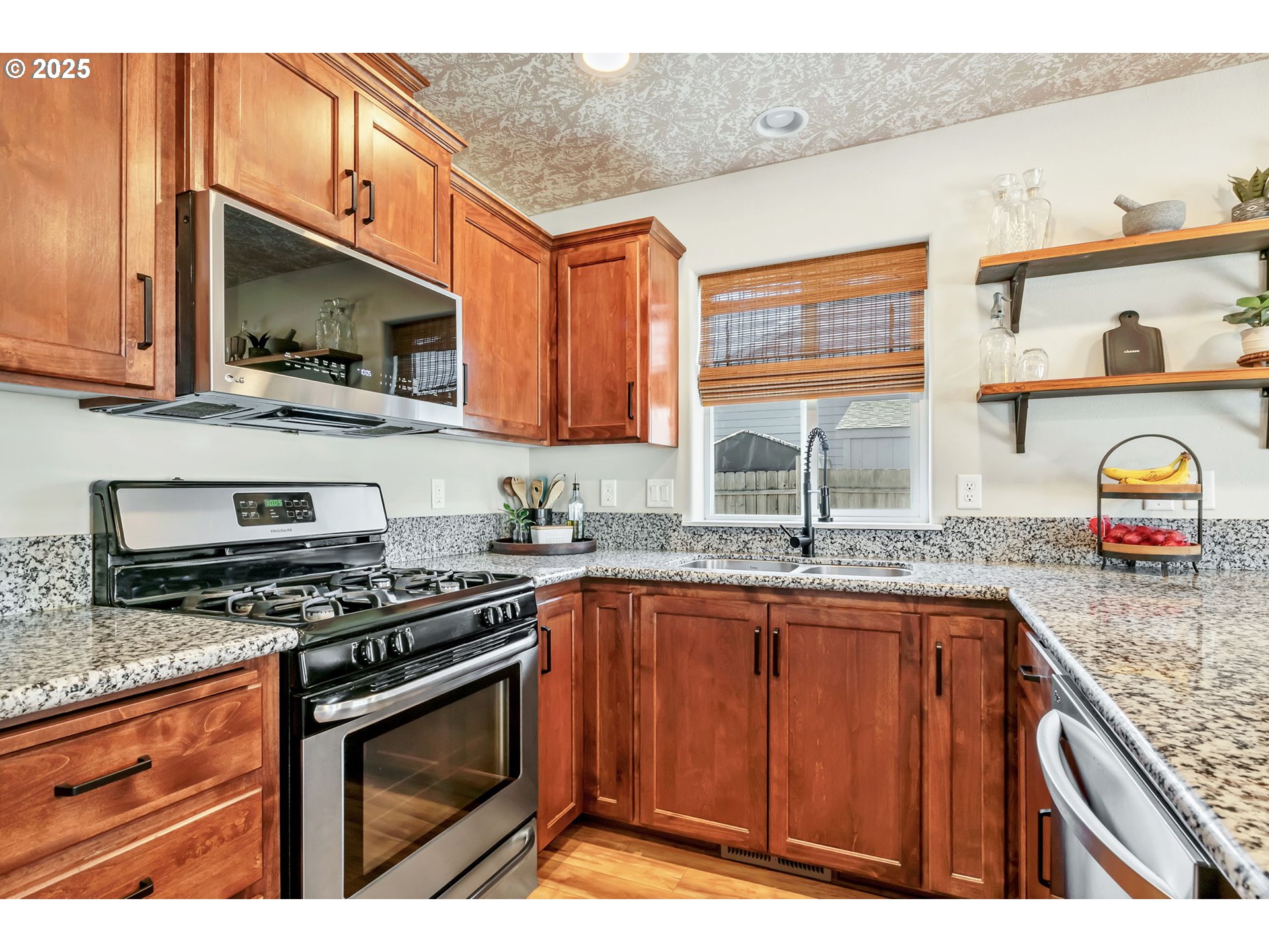 525 12th Street Aumsville, OR 97325 - Photo 7 of 23 a kitchen with stainless steel appliances granite countertop a sink stove and microwave