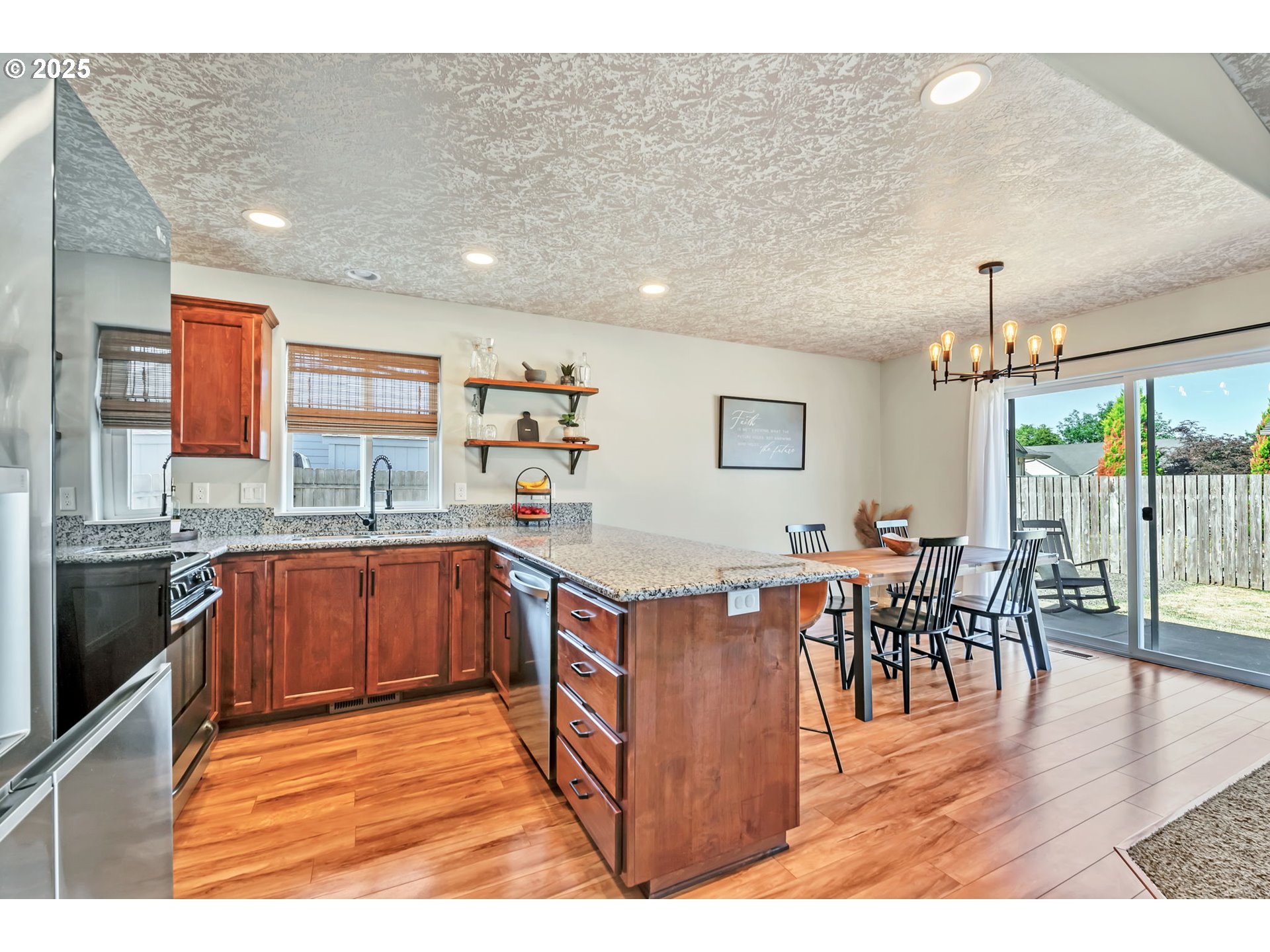 525 12th Street Aumsville, OR 97325 - Photo 8 of 23 a kitchen with stainless steel appliances granite countertop a table chairs and a stove