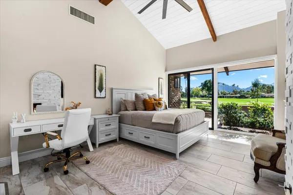 a living room with furniture a fireplace and a floor to ceiling window