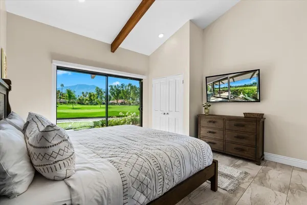 a bedroom with a bed and a view of walk in closet