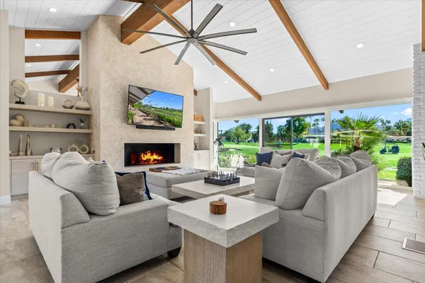 a living room with fireplace furniture and a flat screen tv